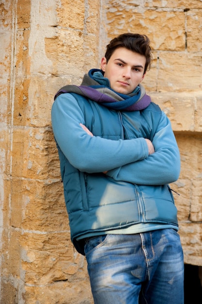 Retrato de um homem modelo contra a parede urbana.