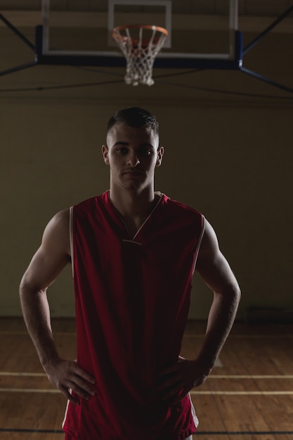 Retrato de um jogador de basquete com as mãos nos quadris