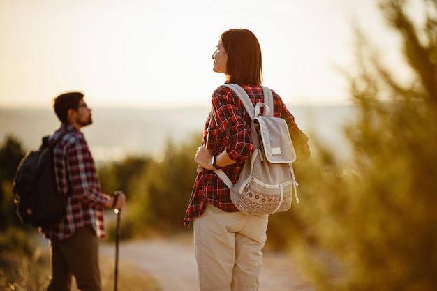 Retrato de um jovem casal feliz se divertindo em sua viagem de caminhada Casal de caminhantes caucasianos e asiáticos se divertindo nas férias de verão