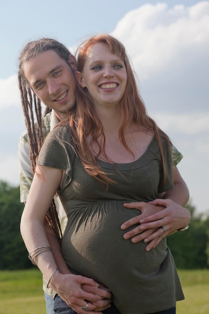 Foto retrato de um jovem casal sorridente esperando um bebê