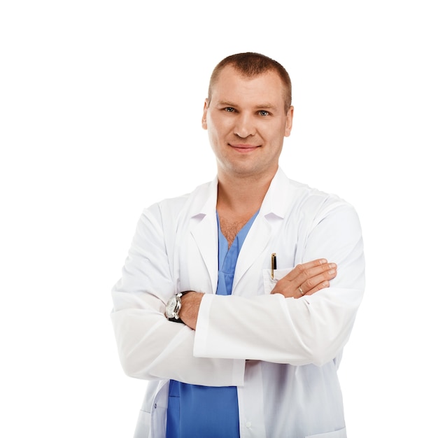 Retrato de um jovem médico em um jaleco branco e uniforme azul contra um branco