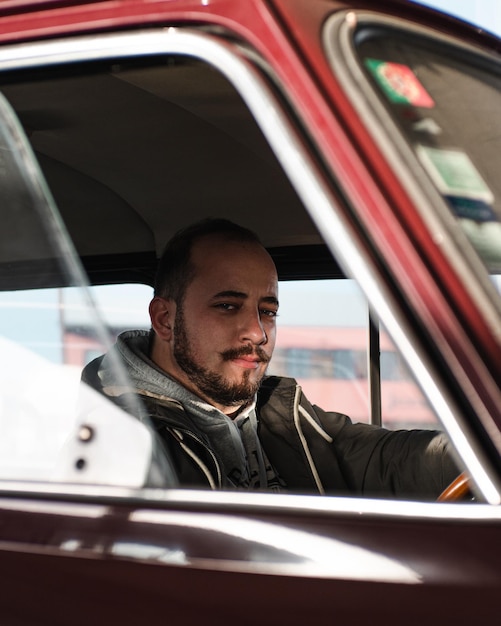 Foto retrato de um jovem sentado no carro