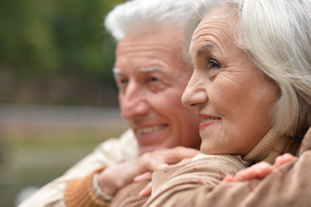 Retrato de um lindo casal feliz de meia-idade no parque outono