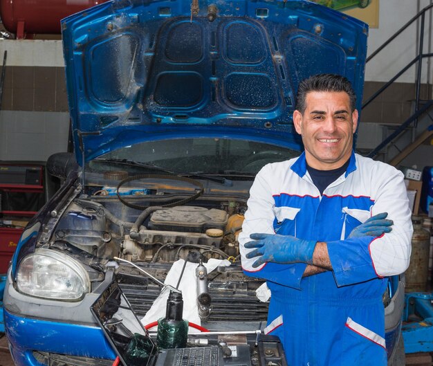 Foto retrato de um mecânico trabalhando em uma oficina de reparação de automóveis