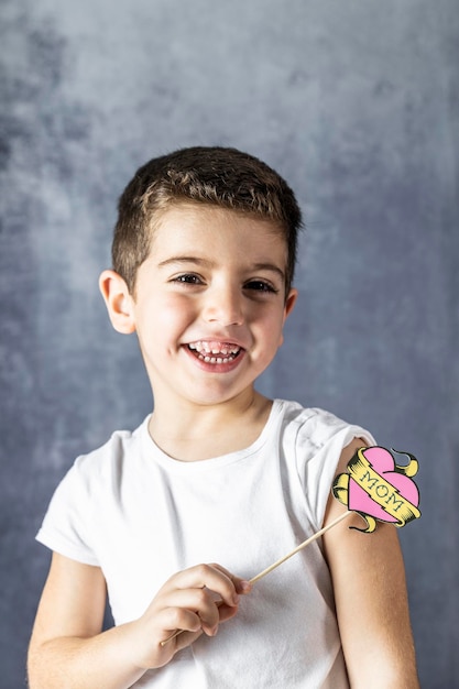 Foto retrato de um menino sorridente segurando um suporte