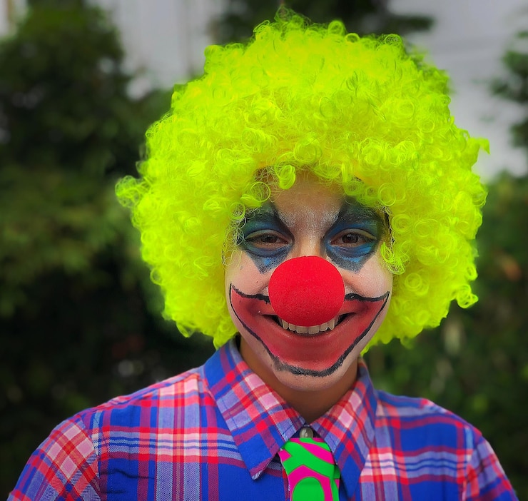 Foto retrato de um menino vestido de palhaço e pintado de rosto