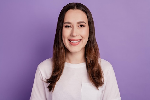 Retrato de uma adorável menina com sorriso dentuço, proteção da cavidade, estomatologia isolada sobre fundo de cor violeta