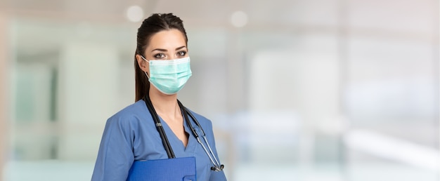 Retrato de uma bela enfermeira mascarada durante uma pandemia de coronavírus