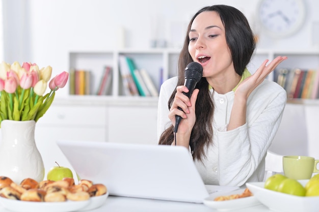 Retrato de uma bela jovem cantando karaokê