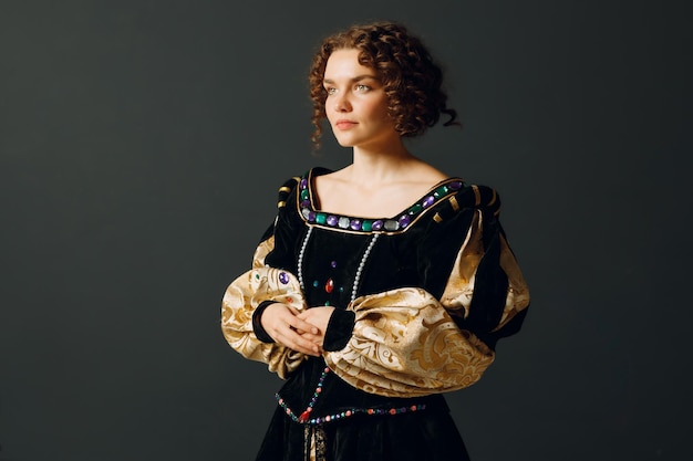 Retrato de uma jovem aristocrática vestida com um vestido medieval em fundo escuro