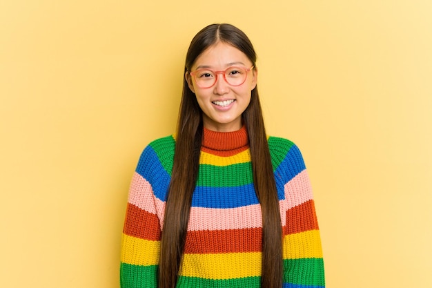 Retrato de uma jovem asiática isolada em fundo amarelo