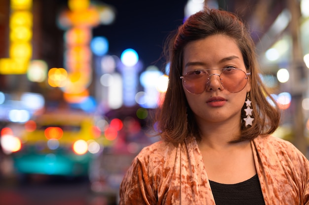 Retrato de uma jovem bela turista asiática explorando Chinatown em Bangkok