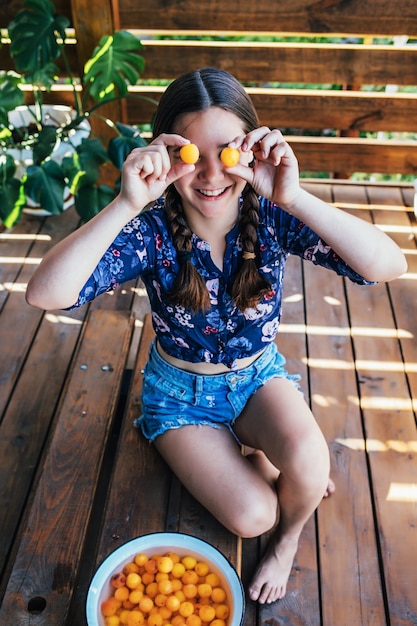 Retrato de uma jovem brincando com frutas