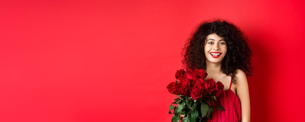 Foto retrato de uma jovem de pé contra um fundo amarelo