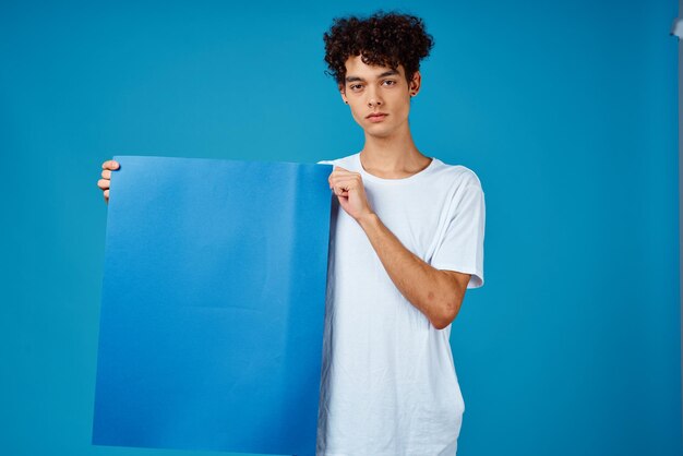 Foto retrato de uma jovem de pé contra um fundo azul