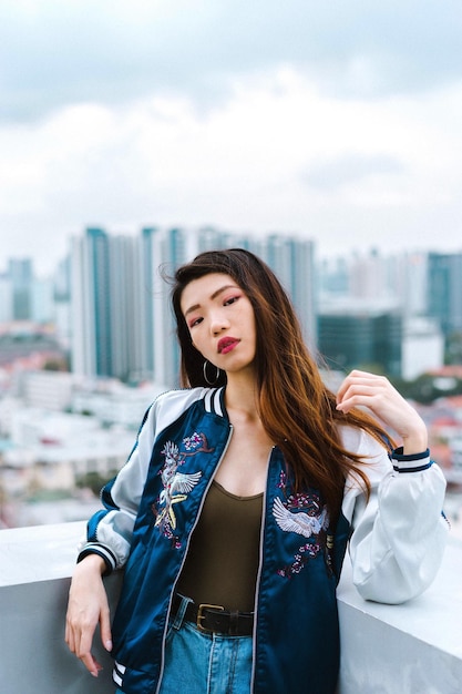 Retrato de uma jovem de pé no terraço do edifício