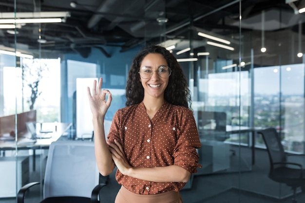 Retrato de uma jovem e linda mulher hispânica freelancer trabalhador seo em óculos fica no