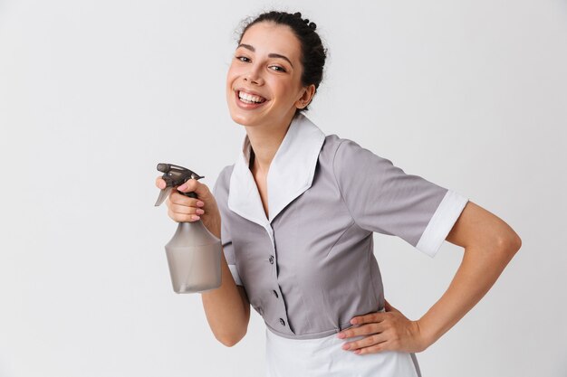 Retrato de uma jovem empregada feliz vestida de uniforme