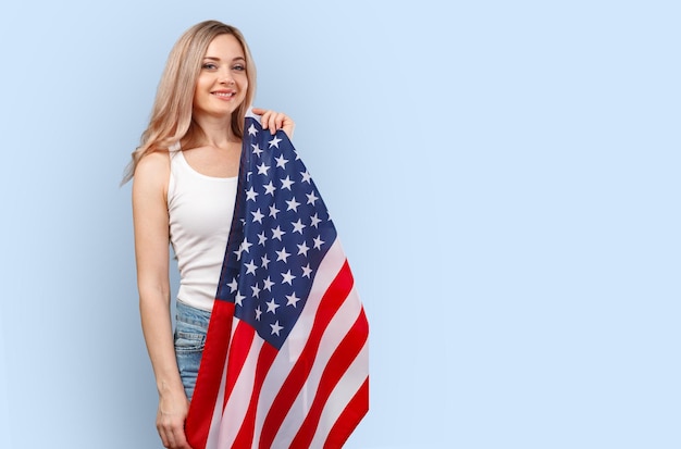 Retrato de uma jovem segurando a bandeira dos eua isolada na cor de fundo