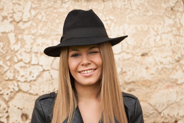 Foto retrato de uma jovem sorridente contra a parede