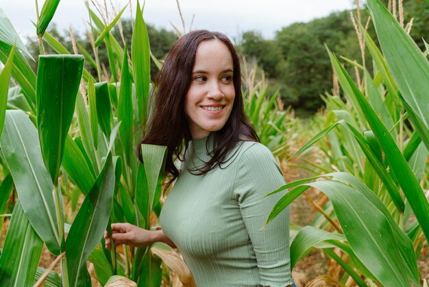 Foto retrato de uma jovem sorridente de pé na fazenda