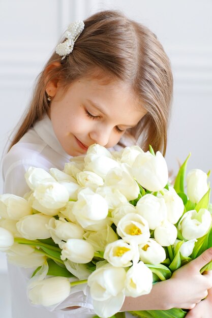 Retrato de uma linda menina bonita com flores brancas