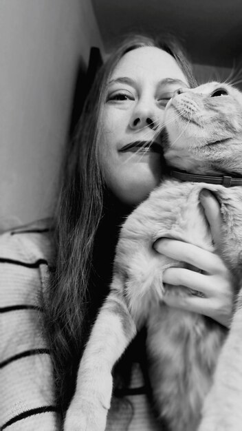 Retrato de uma linda mulher com um gato em casa.