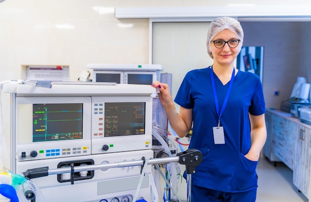 Retrato de uma médica no hospital Mulher olhando para a câmera e sorrindo Fundo de equipamentos modernos