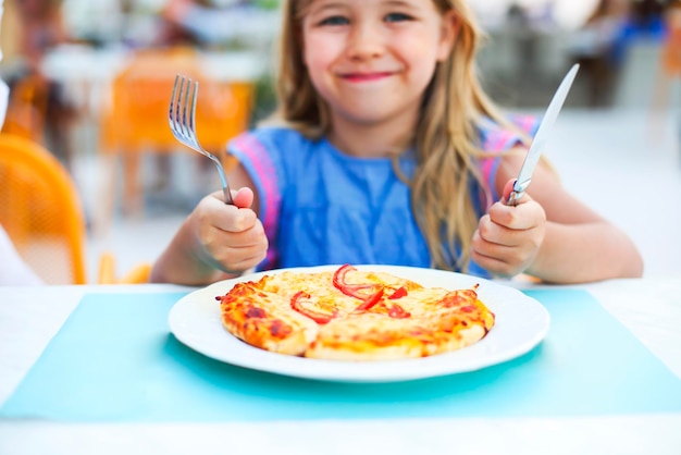 Foto retrato de uma menina com sorvete num restaurante