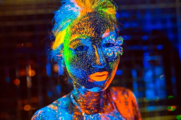 Retrato de uma menina pintada em pó fluorescente.