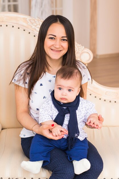 Foto retrato de uma menina sorridente sentada no sofá em casa