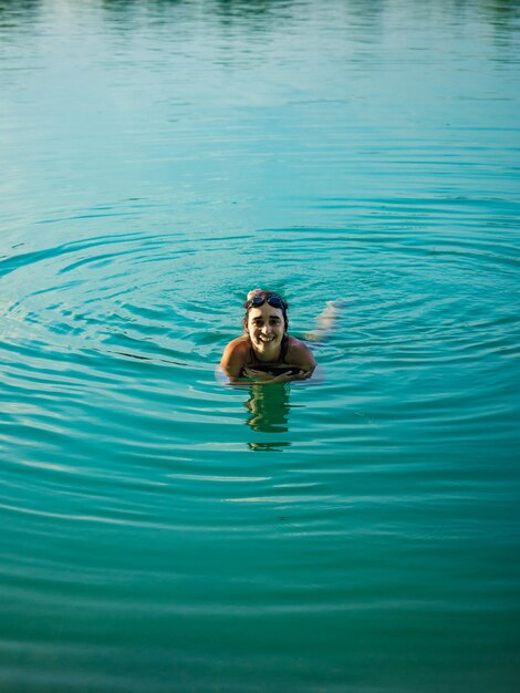Foto retrato de uma mulher alegre nadando no lago