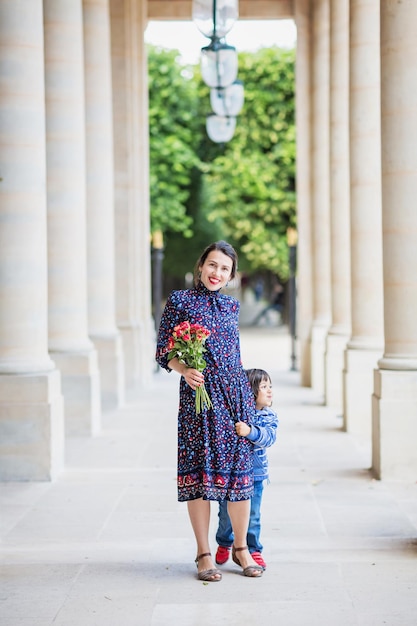 Retrato de uma mulher elegante em um vestido azul posando ao lado de um prédio da cidade