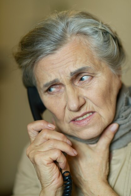 Retrato de uma mulher idosa ligando para o médico