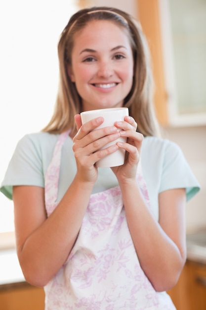 Retrato de uma mulher tomando uma xícara de café