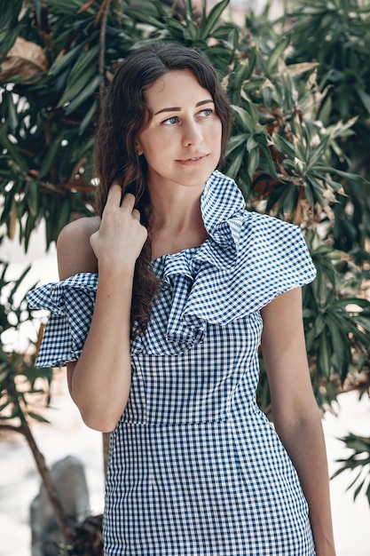 Retrato de uma mulher viajante feliz em um vestido xadrez de verão. Fundo da natureza. Ásia, viagem de viagem de férias de férias de verão. Phuket. Tailândia