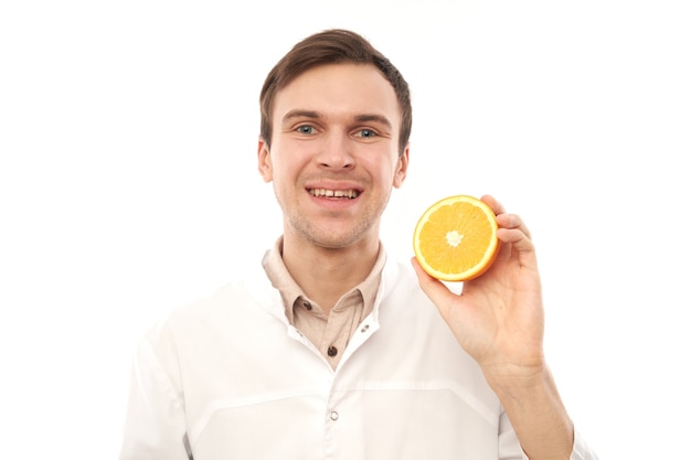 Retrato de uma nutricionista médica sorridente positiva com laranjas. Coma vitamina C, mantenha-se saudável, faça dieta alimentar no conceito de gripe e resfriados