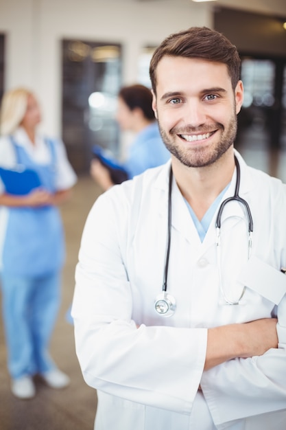 Retrato do médico homem sorridente com os braços cruzados