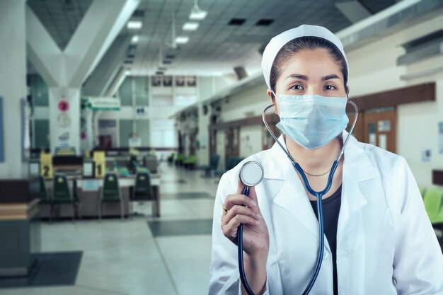 Foto retrato de una doctora de pie en un hospital