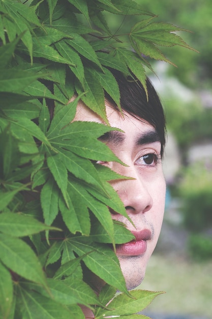 Foto retrato em close-up de um jovem junto a uma árvore