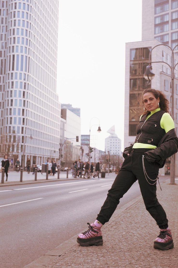 Foto retrato em todo o comprimento de uma mulher de pé contra edifícios na cidade