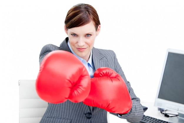 Retrato de una empresaria confiada que lleva guantes de boxeo