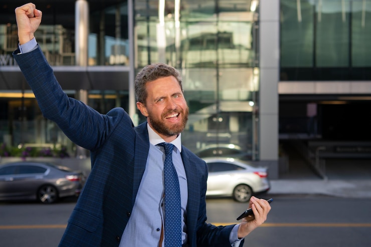 Foto retrato del empresario ganador emocionado frente a la oficina moderna