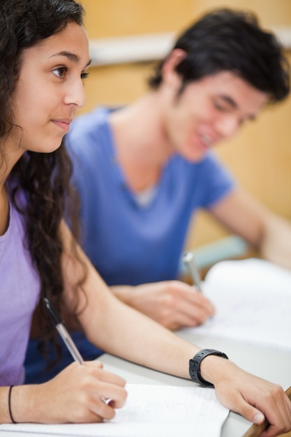 Foto retrato de estudiantes sonrientes escribiendo