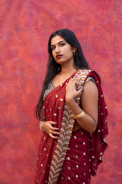 Foto retrato de estudio de mujer joven vistiendo una prenda tradicional sari