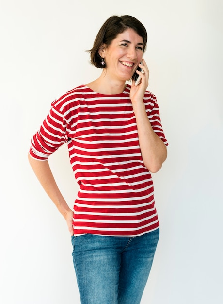 Foto retrato de estudio de teléfono de uso de sonrisa de mujer adulta