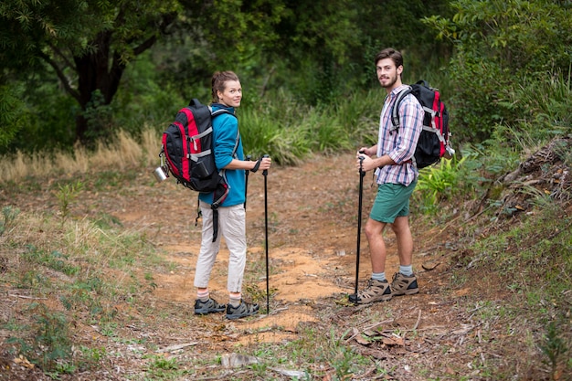 Retrato de excursionista pareja de pie con bastón de senderismo