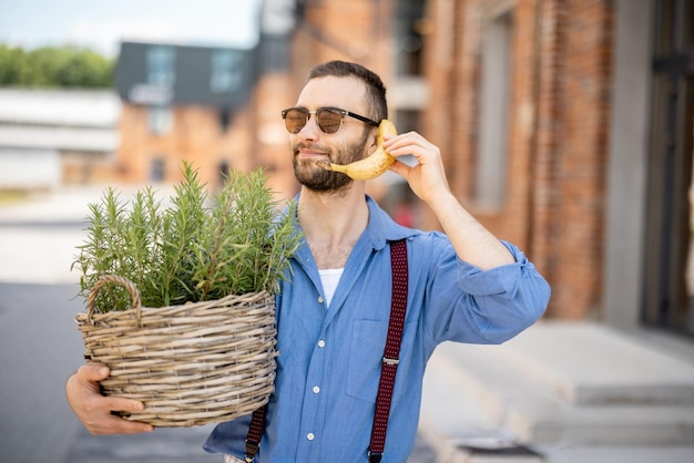 Retrato de extraño elegante hombre de negocios con plátano al aire libre