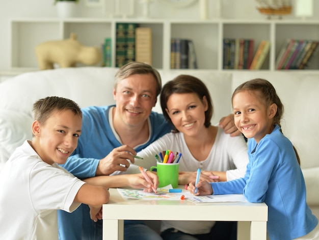 Retrato de familia feliz pintando en casa