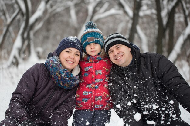 Retrato de familia feliz en ropa de abrigo en invierno al aire libre